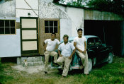 Saipan 1956 Collection, No. 13 Three Men Sitting On A Car  